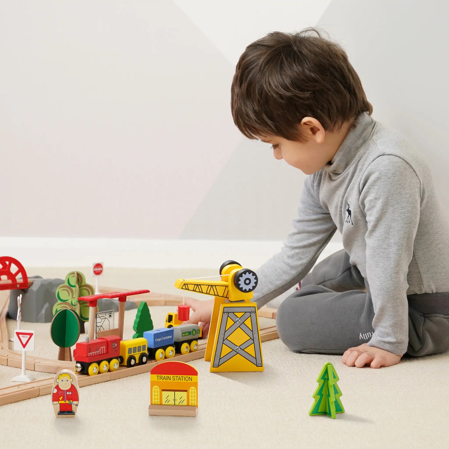 Preschooler building custom track layout during pretend play