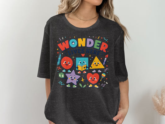 T-shirt with "Wonder Lives Here" and cartoon shapes.