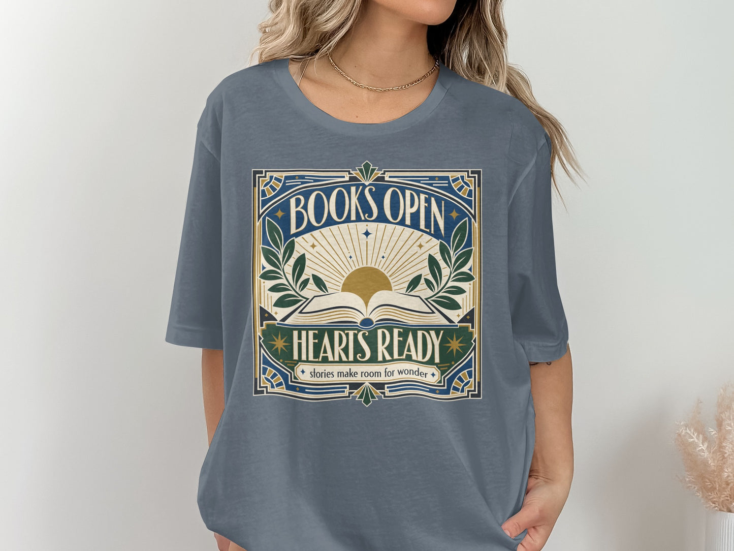 Graphic tee with "BOOKS OPEN HEARTS READY stories make room for wonder" text and sunburst.