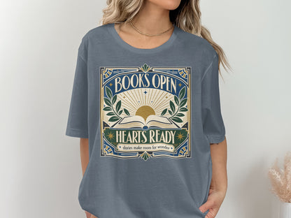 Graphic tee with "BOOKS OPEN HEARTS READY stories make room for wonder" text and sunburst.