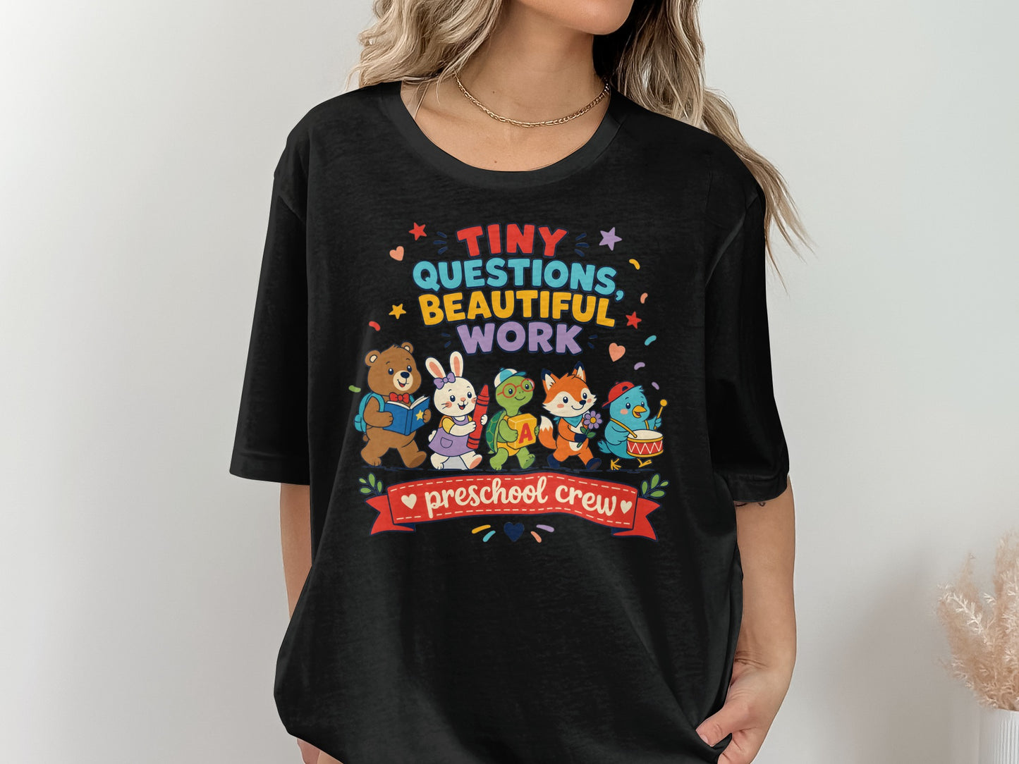 Black t-shirt with "Tiny Questions, Beautiful Work" and "preschool crew" text.