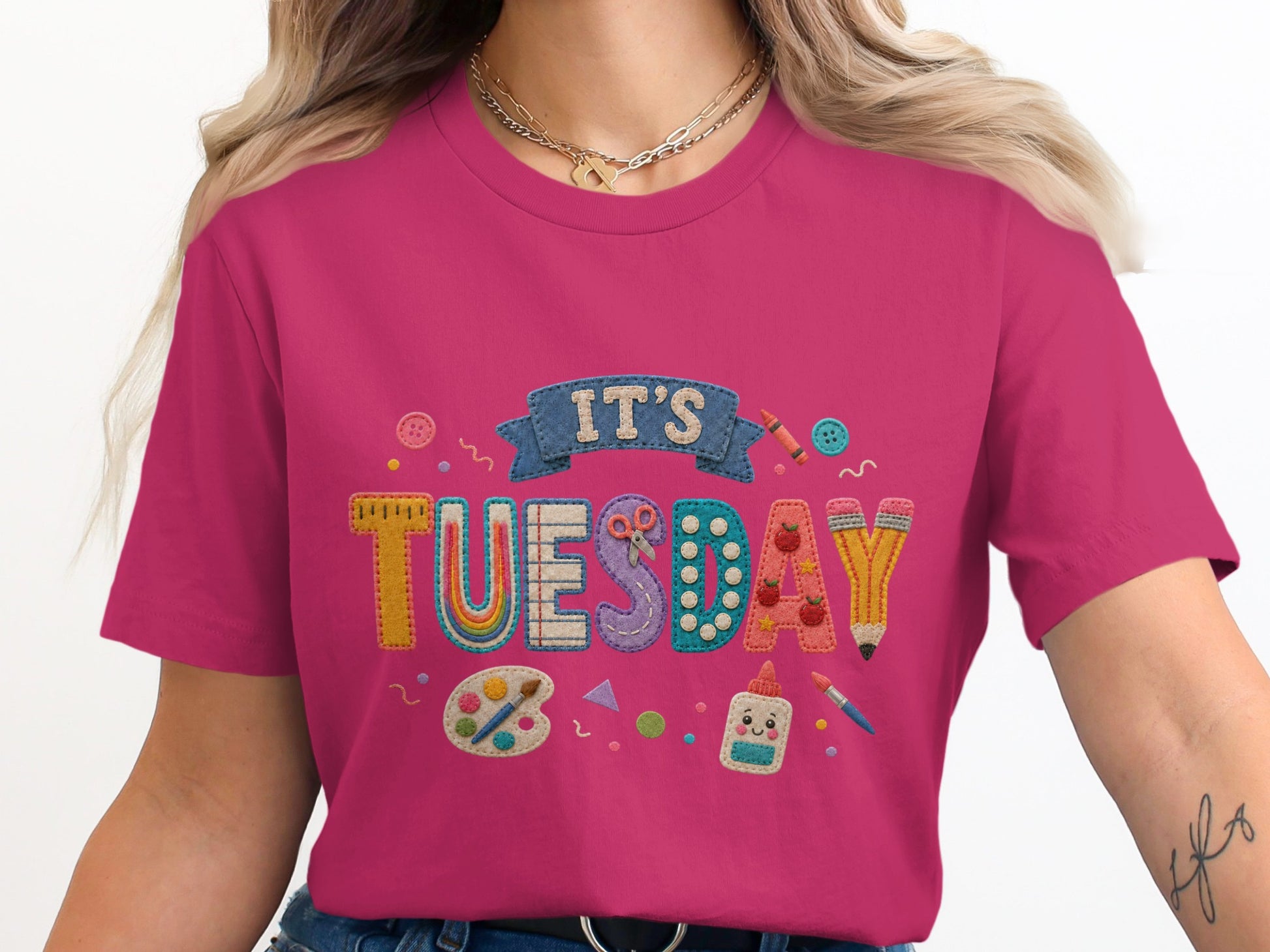 Pink t-shirt with "It's Tuesday" graphic featuring art supplies.