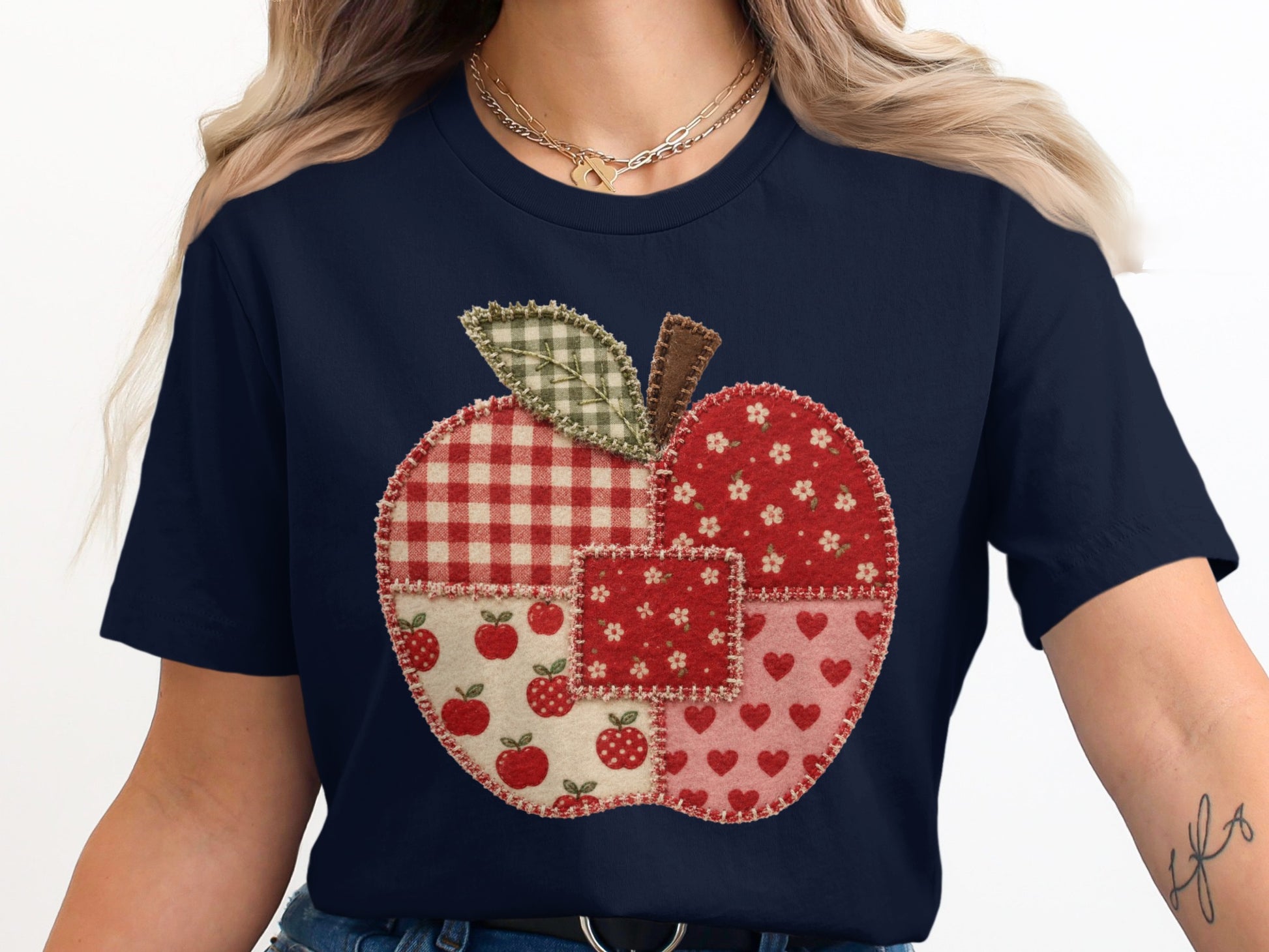Navy t-shirt with a quilted patchwork apple graphic on the front.