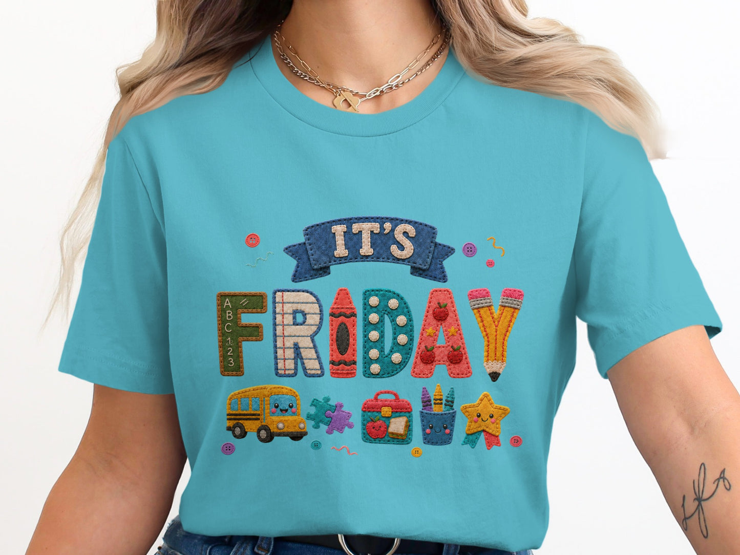 It's Friday graphic with school icons and lettering on a blue t-shirt.