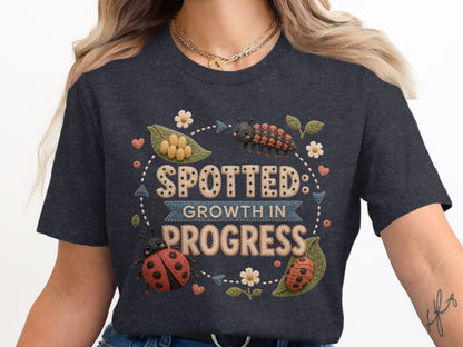 "Spotted: Growth in Progress" text with ladybugs and caterpillar on t-shirt.