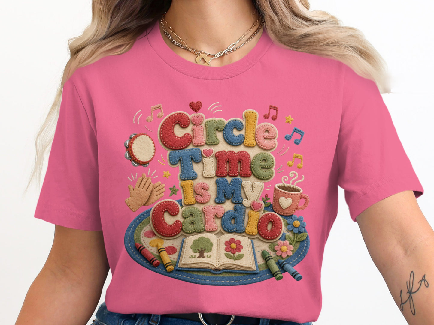 Pink t-shirt with embroidered text "Circle Time is My Cardio" and playful school-themed graphics.