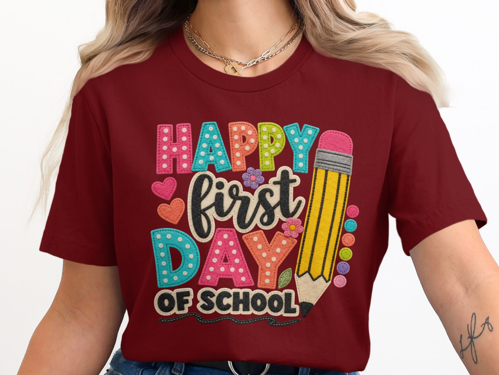 Maroon t-shirt with "Happy First Day of School" text and pencil graphic.