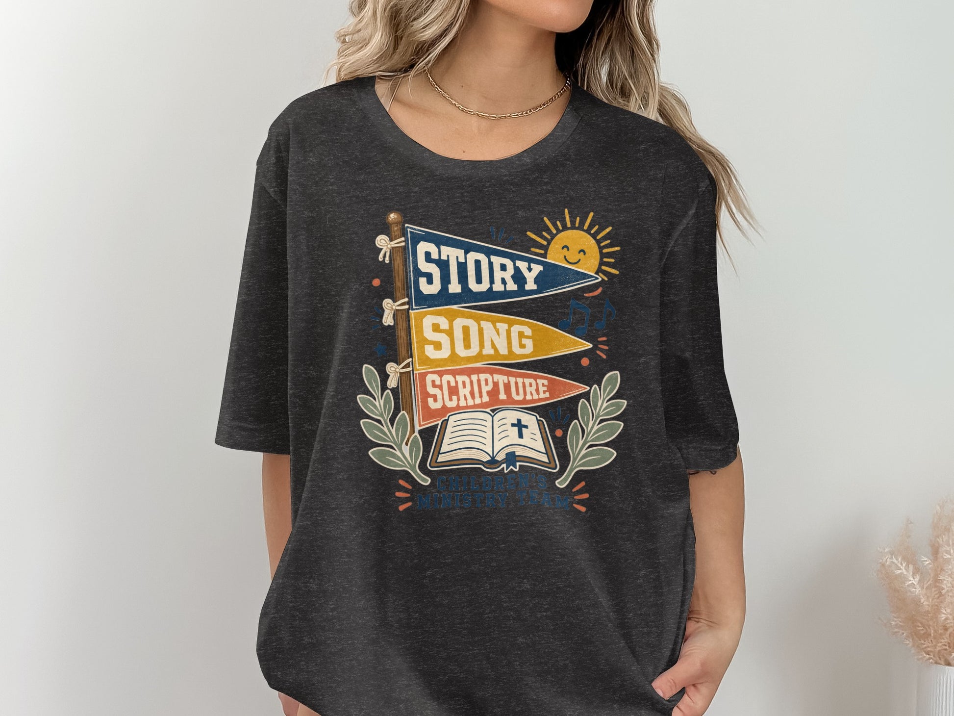 Dark t-shirt with "Story Song Scripture Children's Ministry Team" graphic.