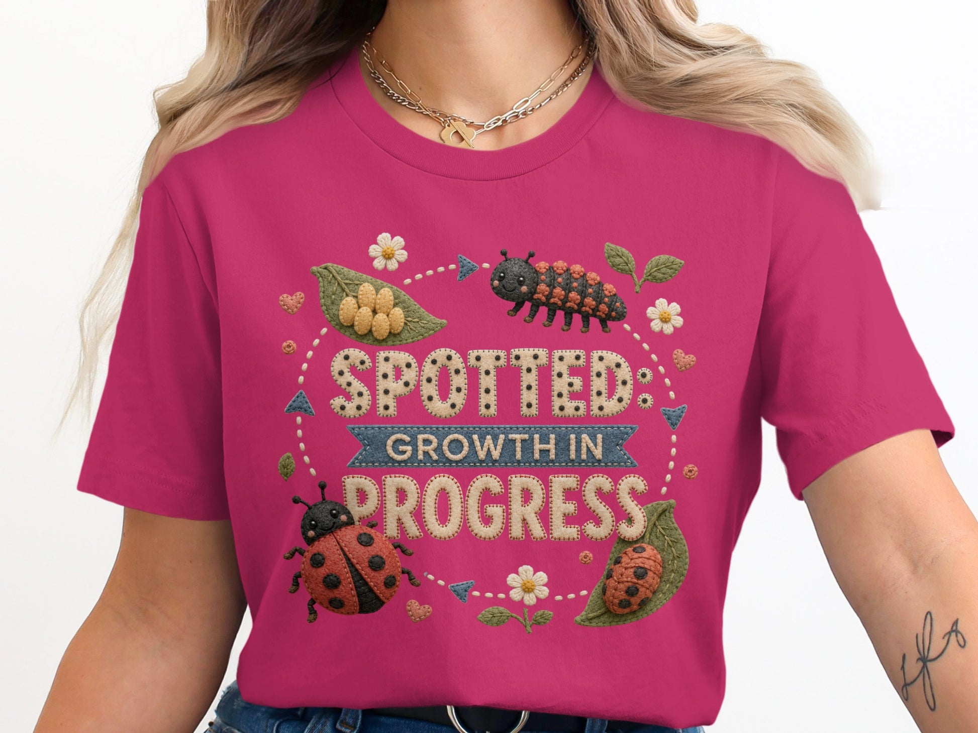 Pink t-shirt with "Spotted Growth in Progress" text with ladybugs and caterpillar.