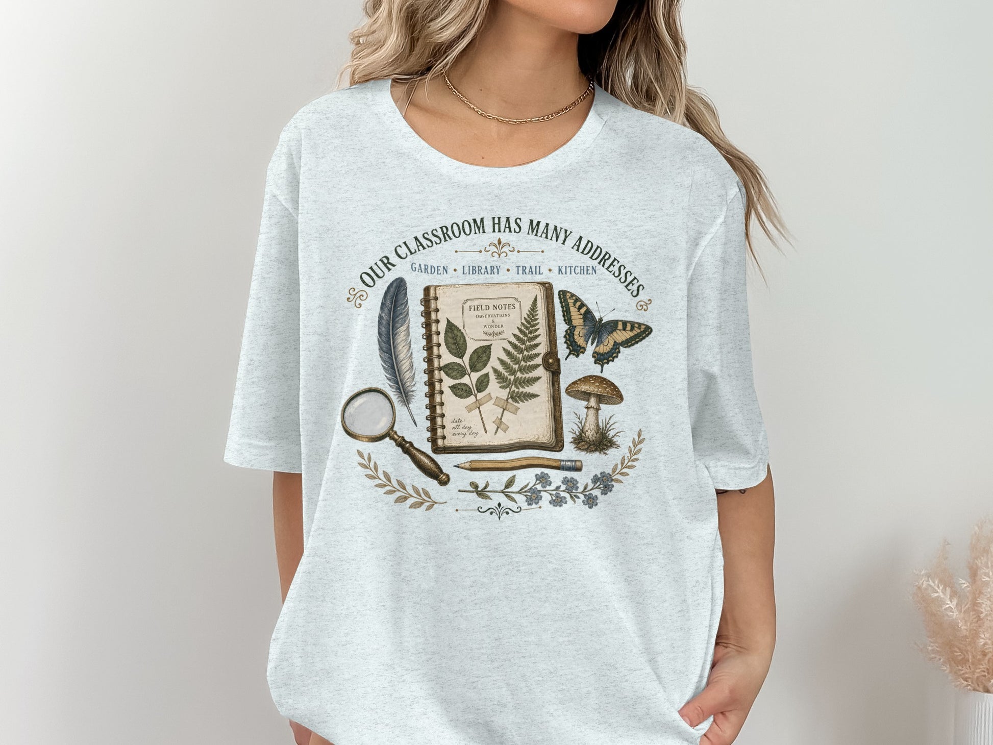 T-shirt with vintage nature illustrations and text "Our classroom has many addresses."