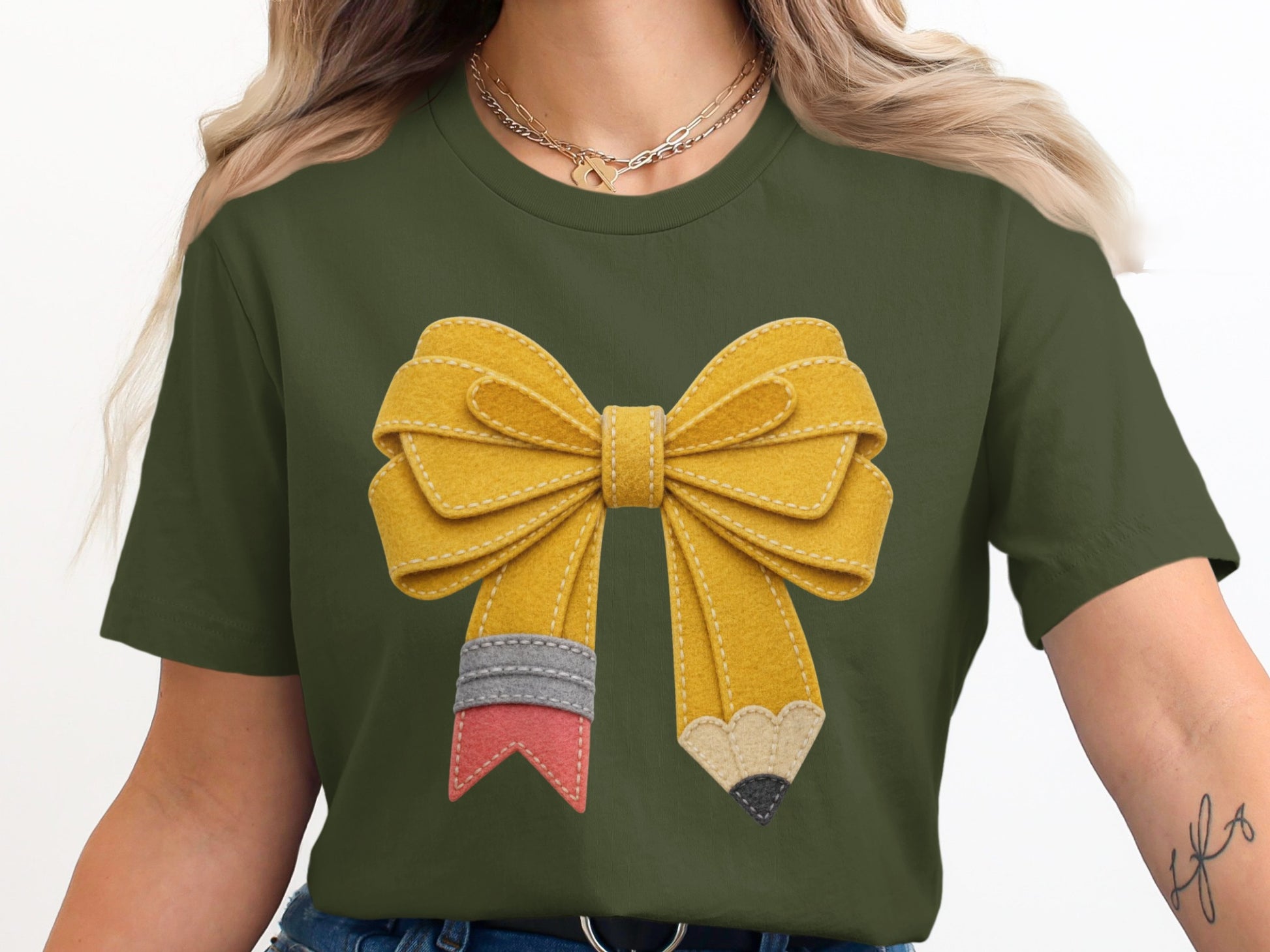Green t-shirt with a yellow pencil-shaped bow graphic across the chest.