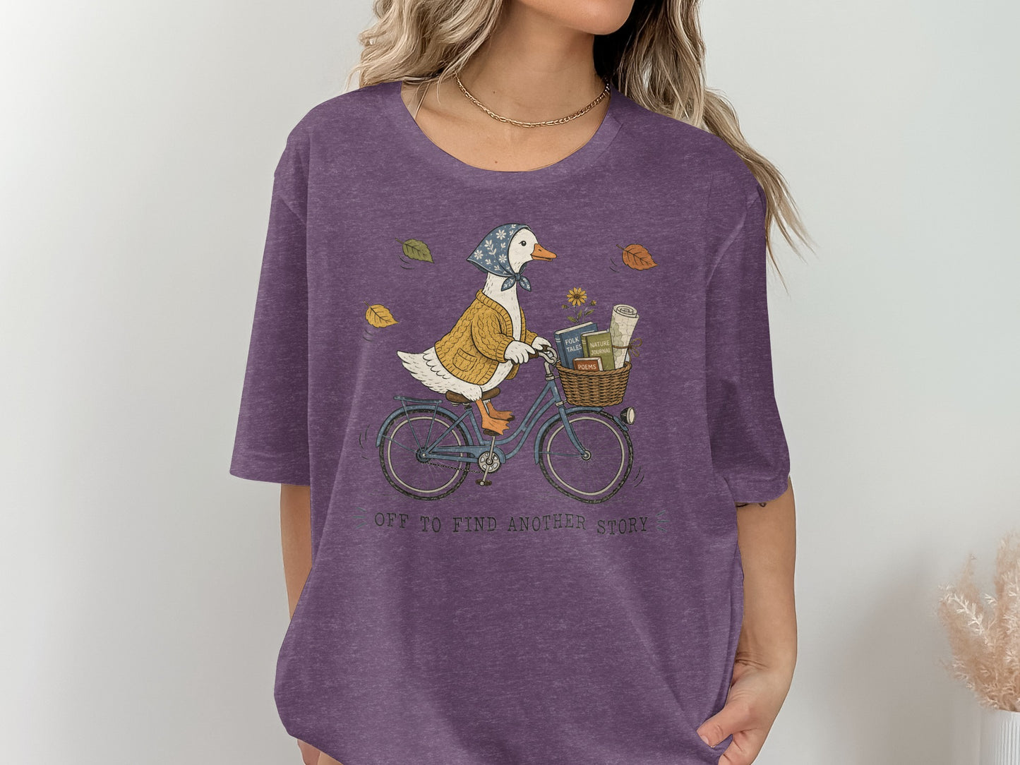 Duck in a sweater and scarf riding a bicycle with books in the basket.