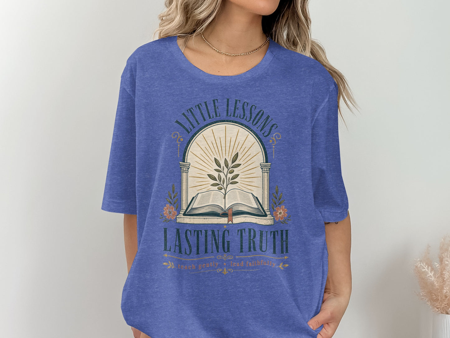 T-shirt with an open book, olive branch, and text "LITTLE LESSONS LASTING TRUTH".
