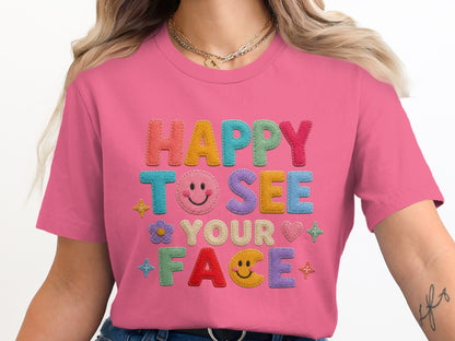 Pink t-shirt with "HAPPY TO SEE YOUR FACE" text and smiley face graphics.