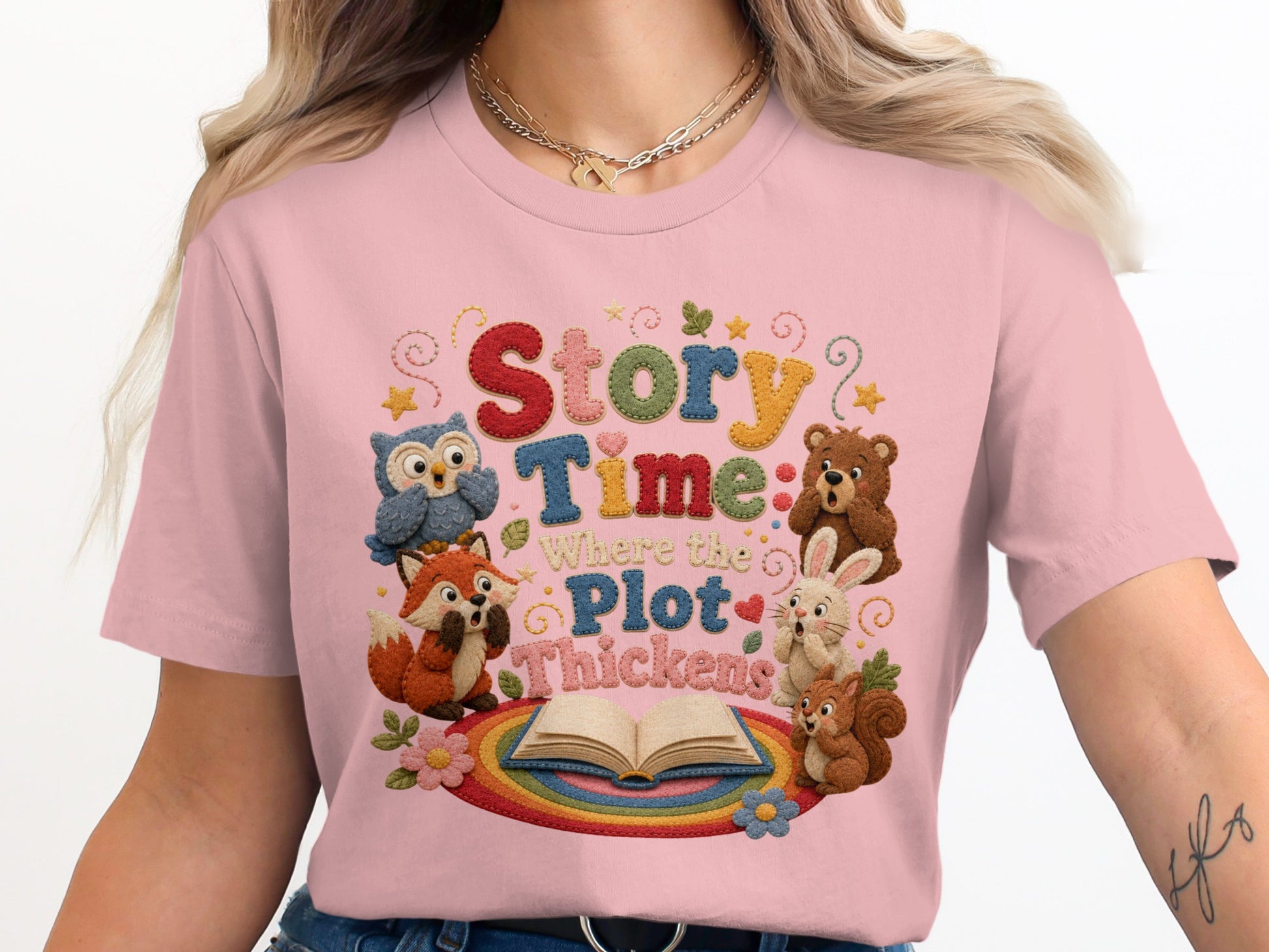 Pink t-shirt with "Story Time Where the Plot Thickens" text and woodland animals.