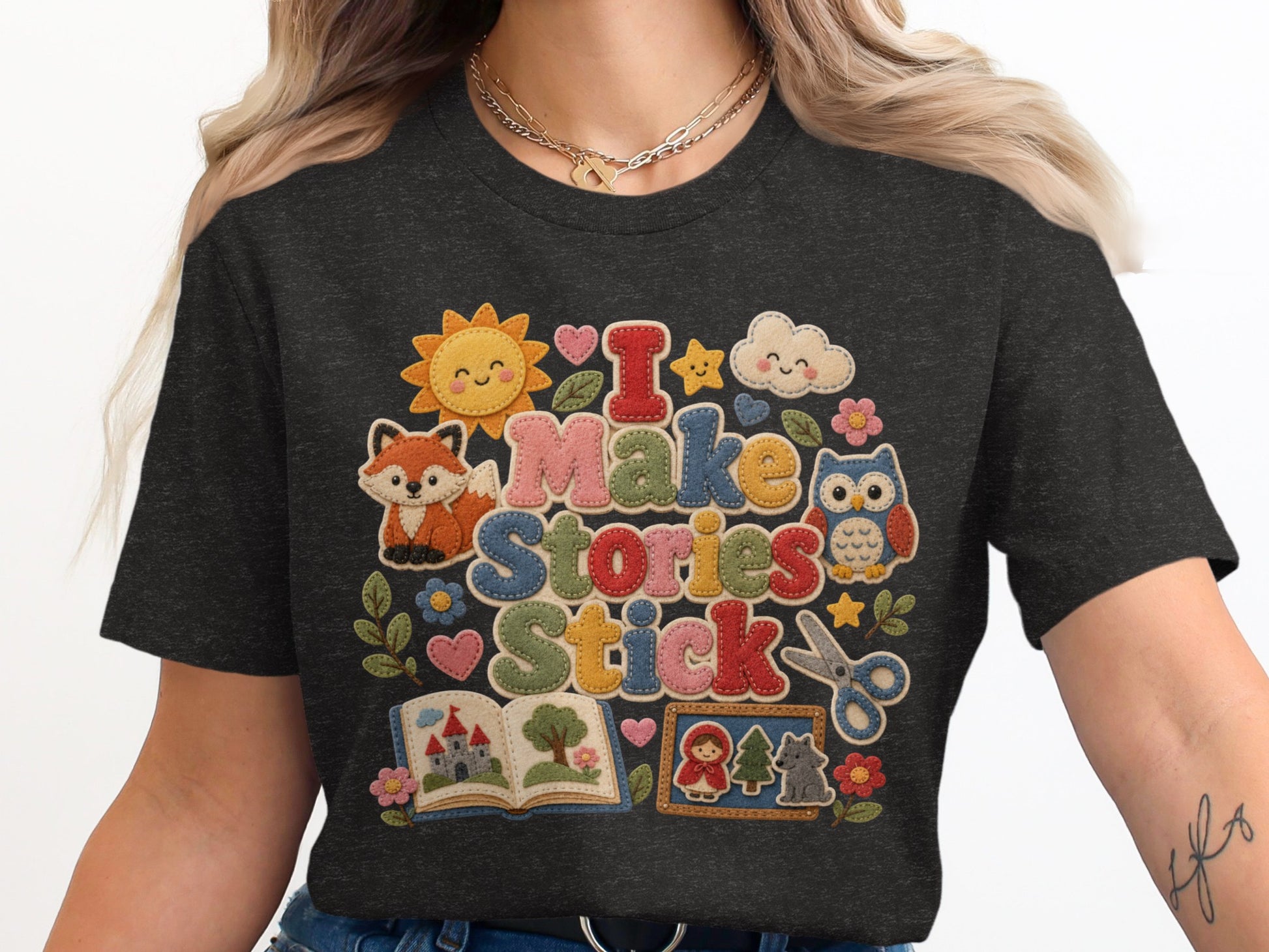 Dark t-shirt with "I Make Stories Stick" text and whimsical story elements.
