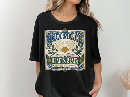 Black t-shirt with "BOOKS OPEN HEARTS READY stories make room for wonder" text and sun design.