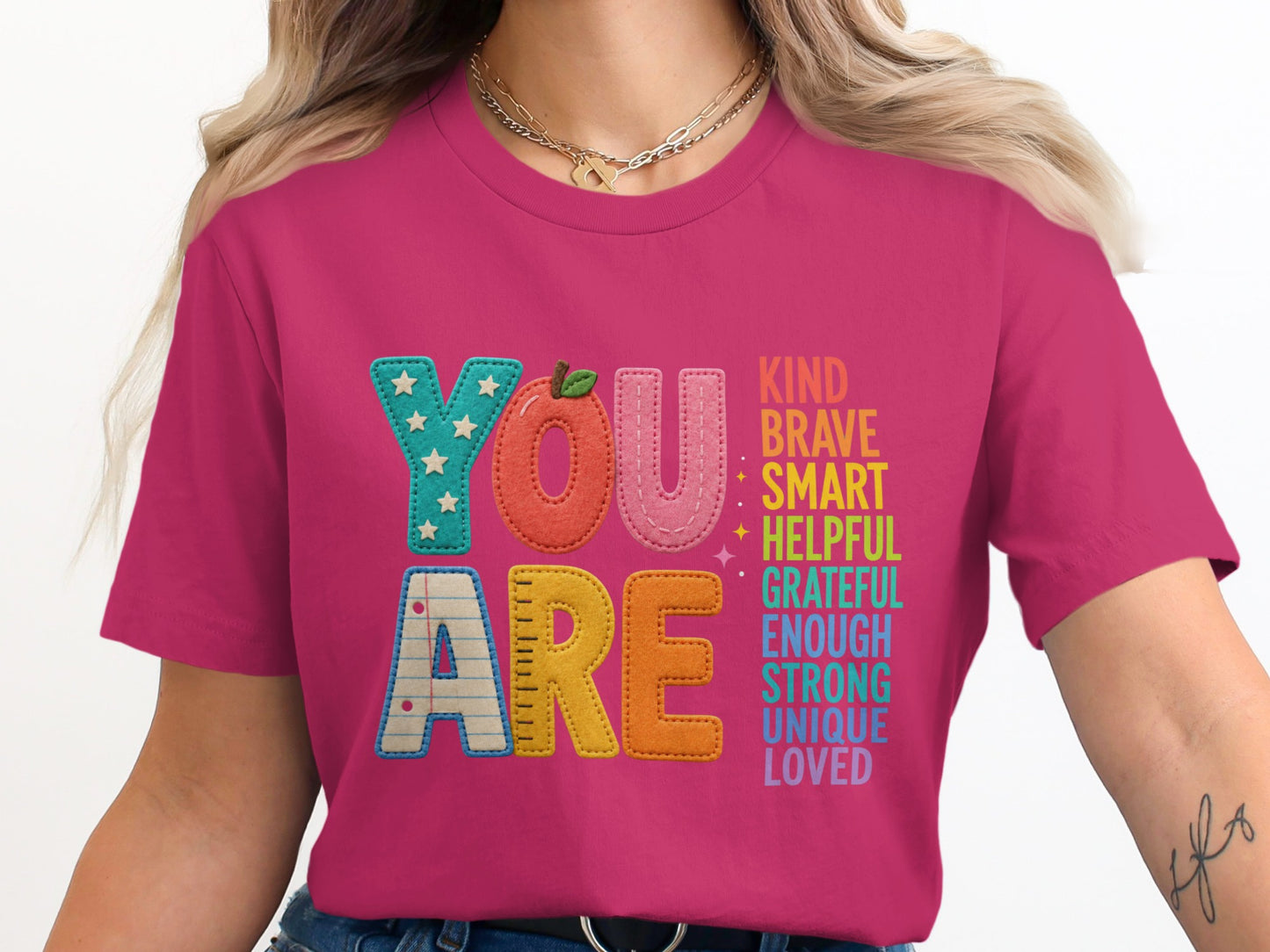 Pink t-shirt with "YOU ARE" and a list of positive adjectives.