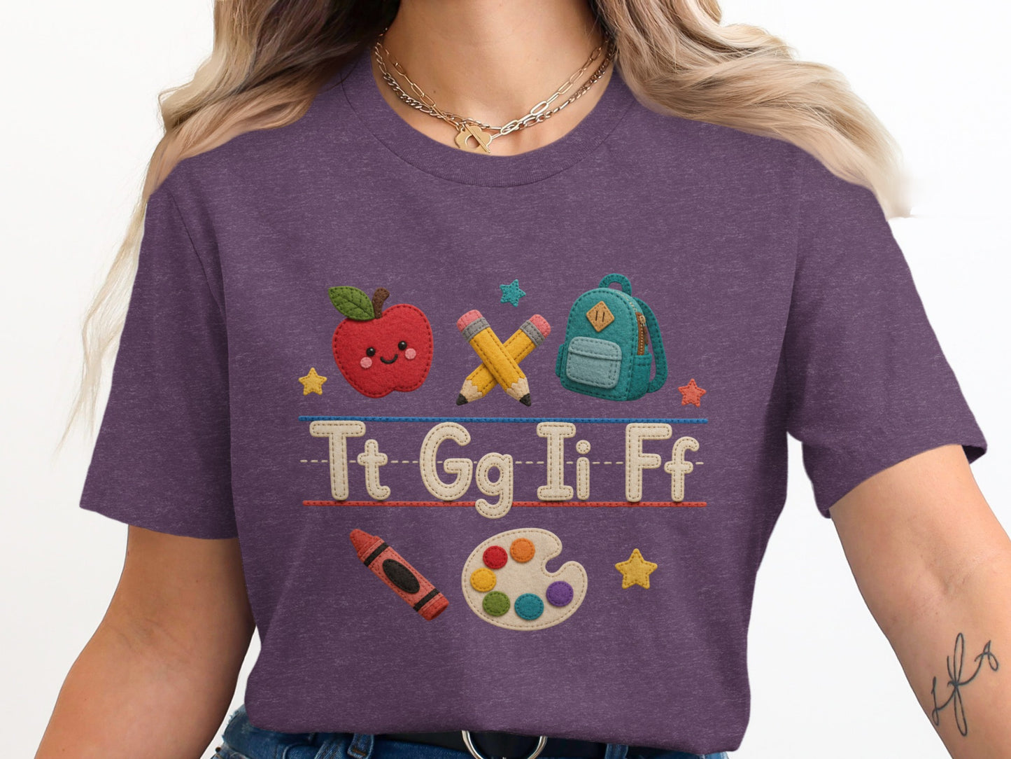 Purple t-shirt with back to school icons and letters Tt Gg Ii Ff.