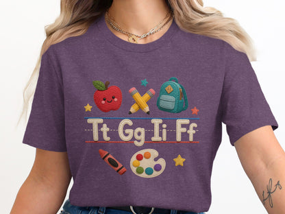 Purple t-shirt with back to school icons and letters Tt Gg Ii Ff.