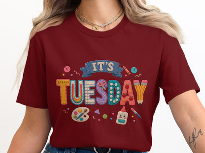 Maroon t-shirt with "IT'S TUESDAY" text and school supplies graphics.