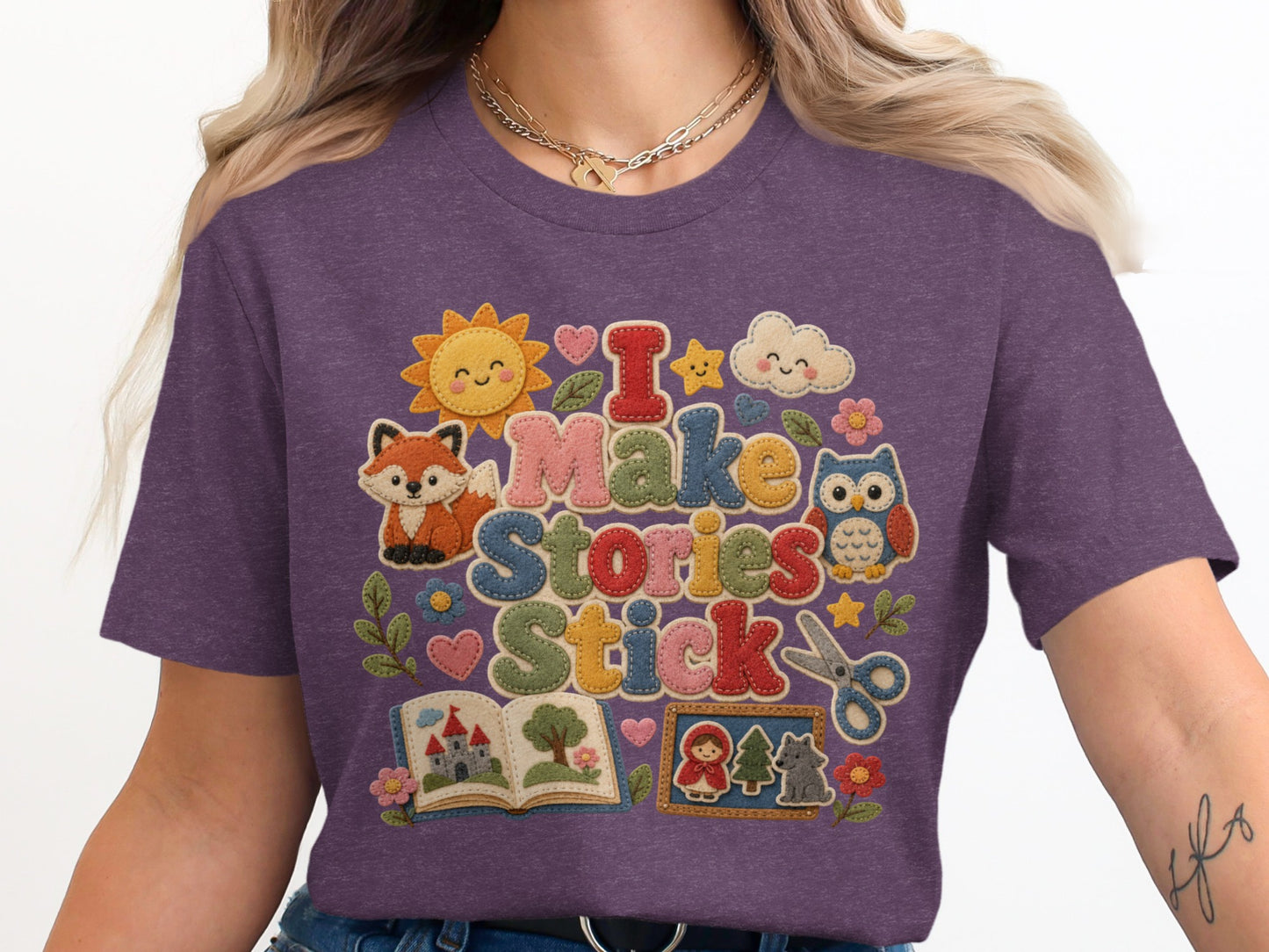 Purple t-shirt with "I Make Stories Stick" text and storybook graphics.