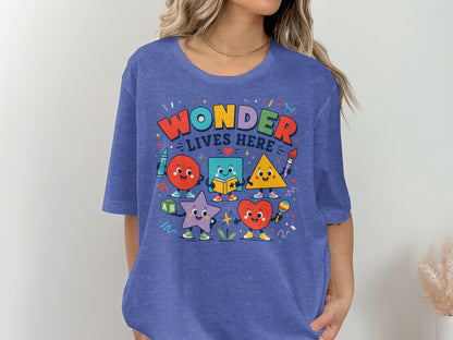 Graphic tee with "Wonder Lives Here" text and cartoon shapes: circle, square, triangle, star, heart.