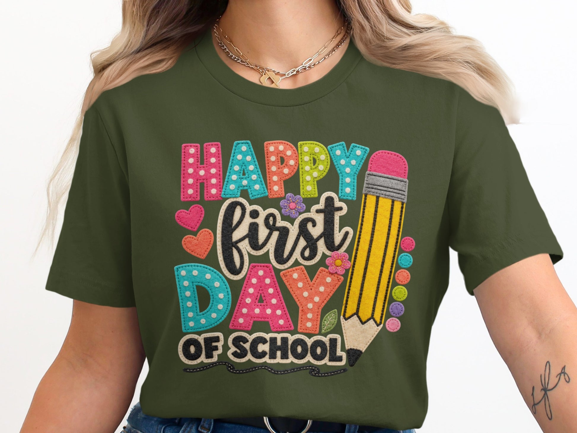 Green t-shirt with "Happy first DAY OF SCHOOL" text and a large pencil.