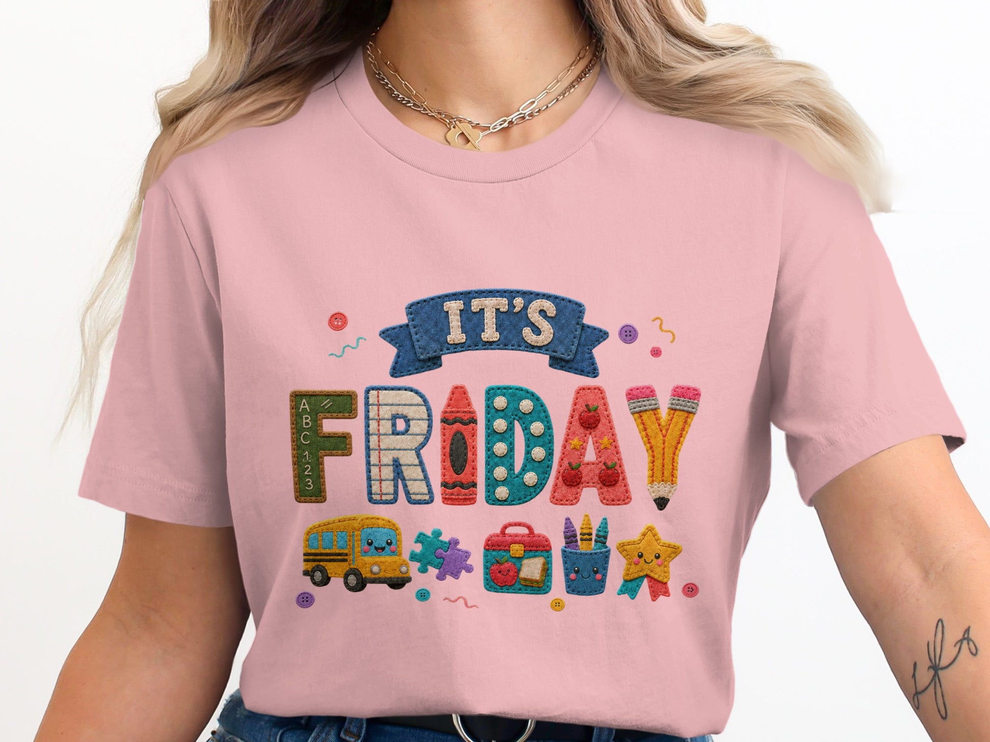 Pink t-shirt with "IT'S FRIDAY" text and school-themed clip art in a playful style.