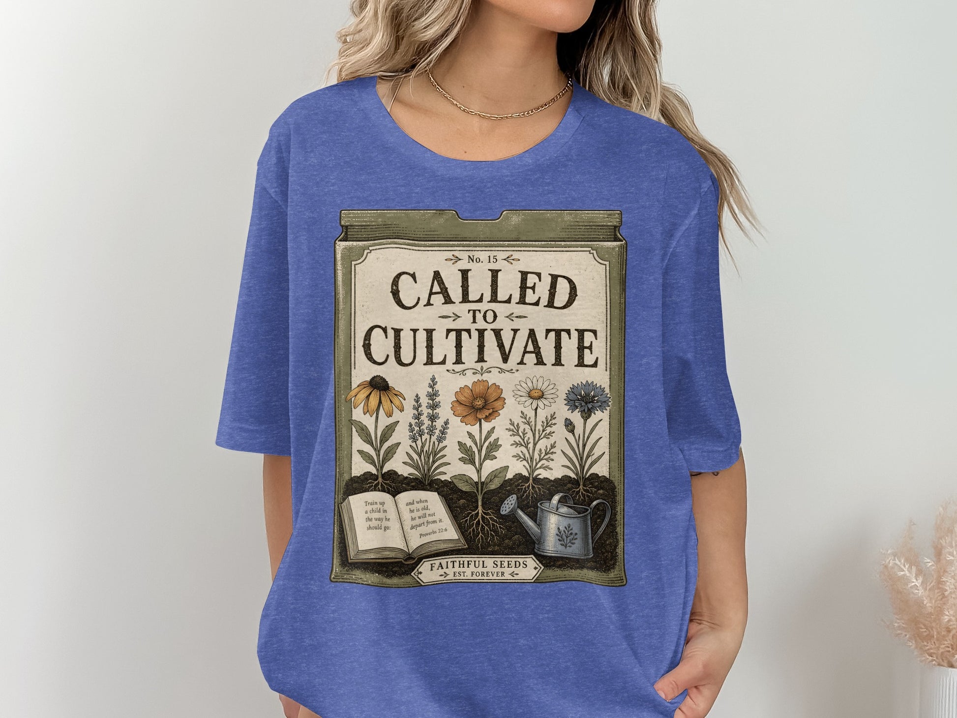 Blue t-shirt with "Called to Cultivate" text and floral illustration.