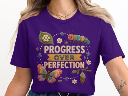 Purple t-shirt with "Progress Over Perfection" text, butterfly, caterpillar, and chrysalis graphic.