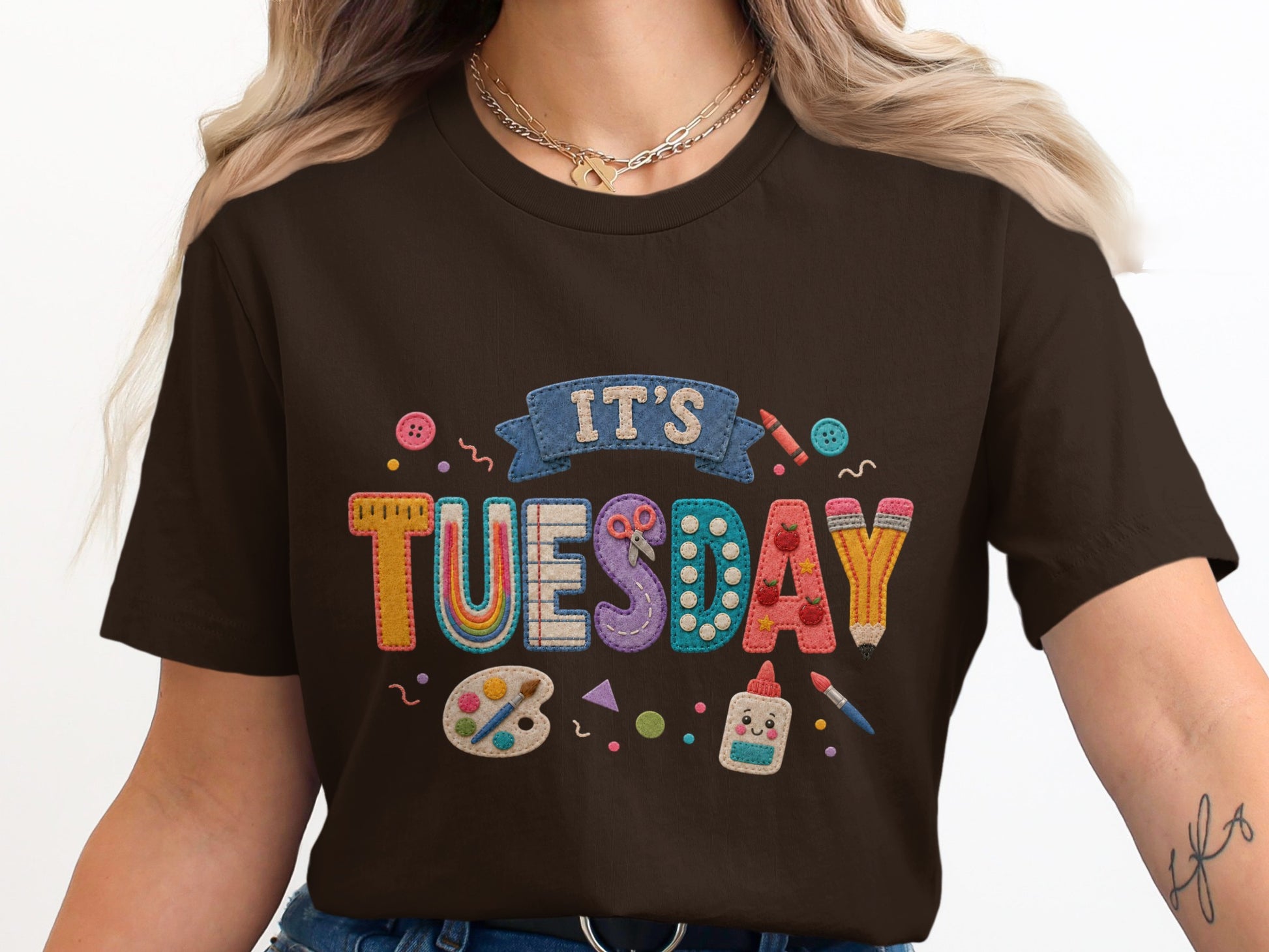 Brown t-shirt with "It's Tuesday" art supplies motif and colorful applique letters.