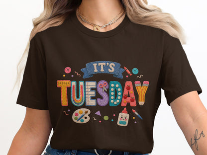 Brown t-shirt with "It's Tuesday" art supplies motif and colorful applique letters.