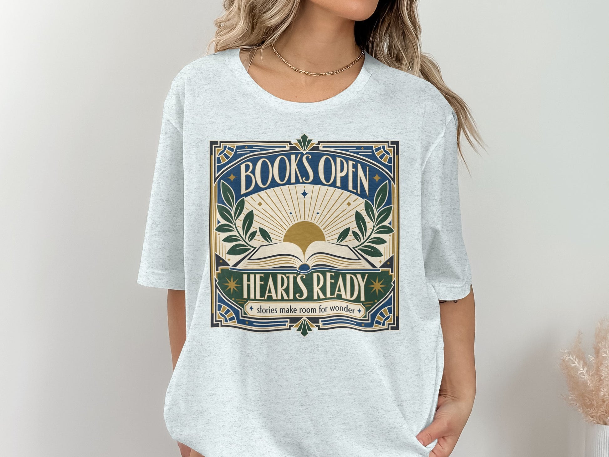 Gray t-shirt with "BOOKS OPEN HEARTS READY stories make room for wonder" text and an open book graphic.
