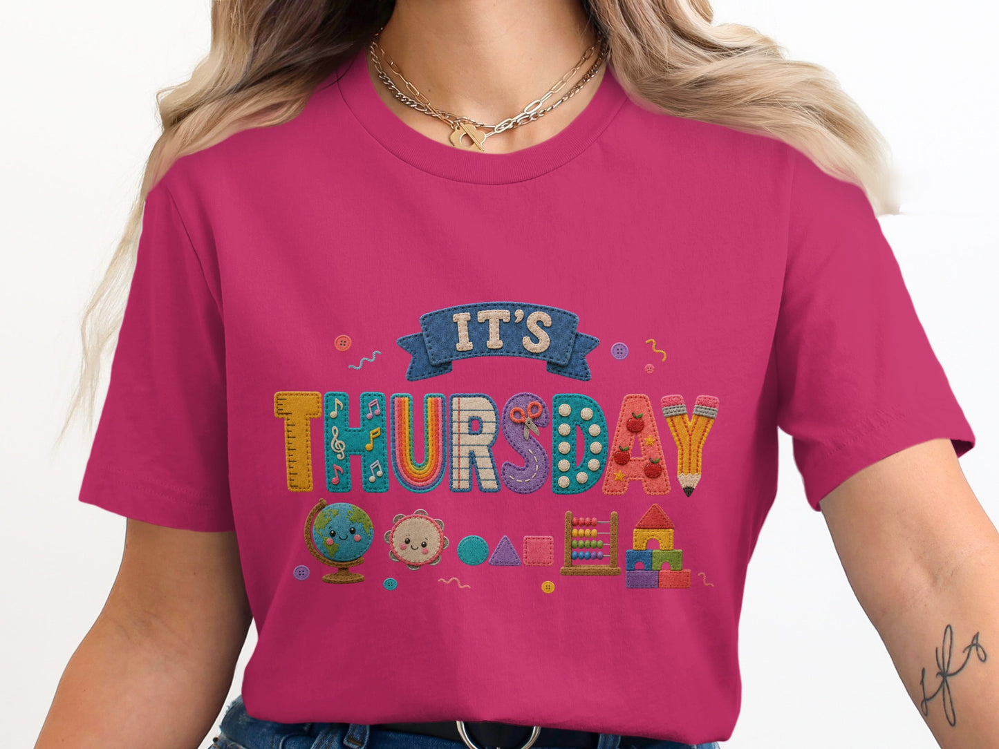 Pink t-shirt with colorful "It's Thursday" text and school-themed icons.