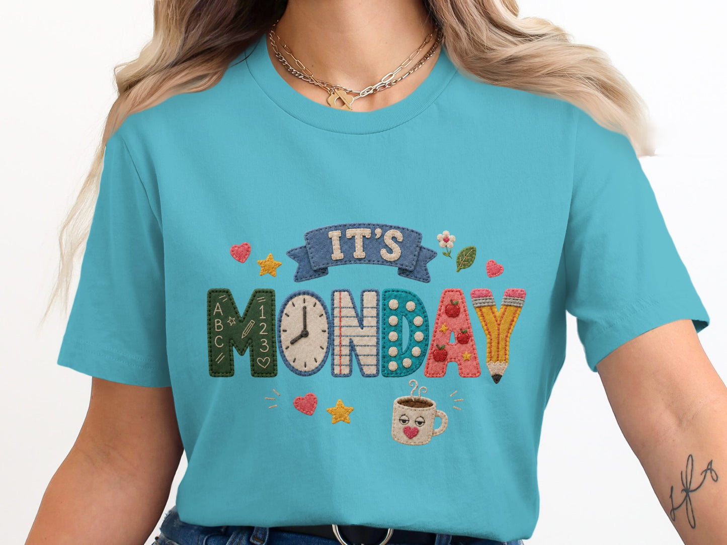 Turquoise t-shirt with "It's Monday" embroidered in colorful, textured letters.