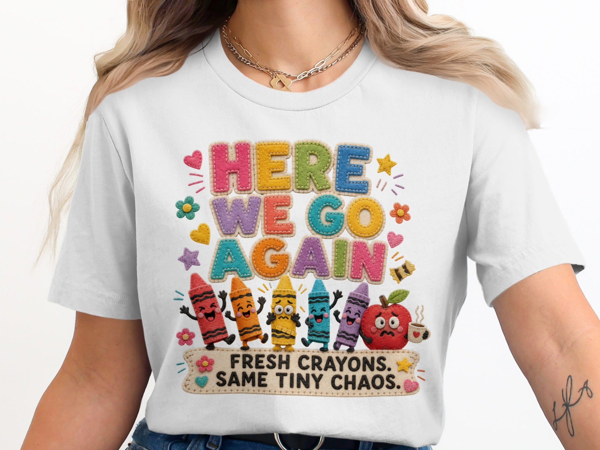 White t-shirt with "HERE WE GO AGAIN" and "FRESH CRAYONS. SAME TINY CHAOS." text.