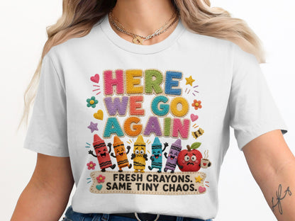 White t-shirt with "HERE WE GO AGAIN" and "FRESH CRAYONS. SAME TINY CHAOS." text.