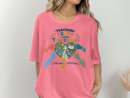 Teaachinf truth with tenderness, little hearts lasting hope graphic on a pink t-shirt.