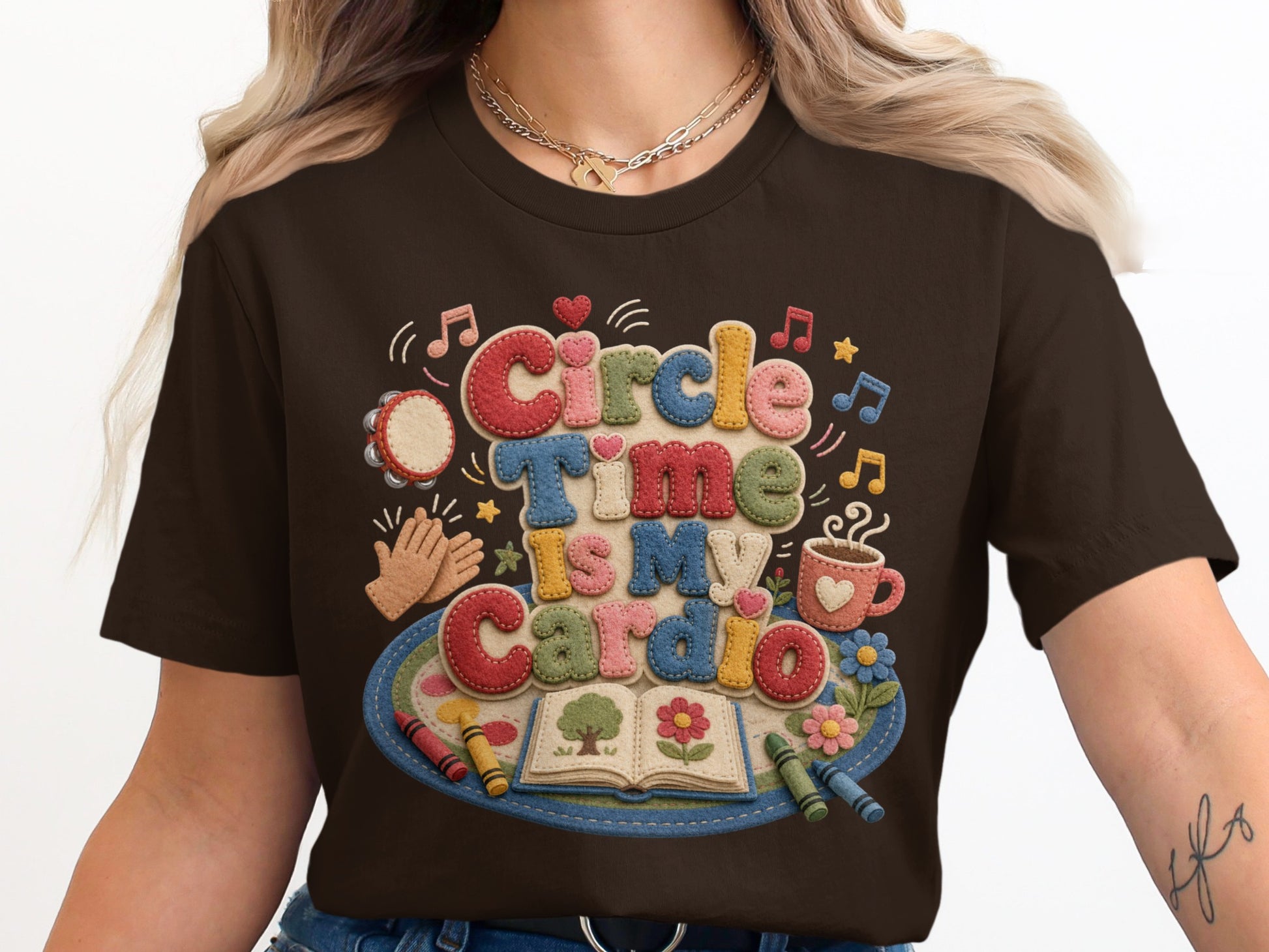 Brown t-shirt with "Circle Time Is My Cardio" text and playful classroom graphics.