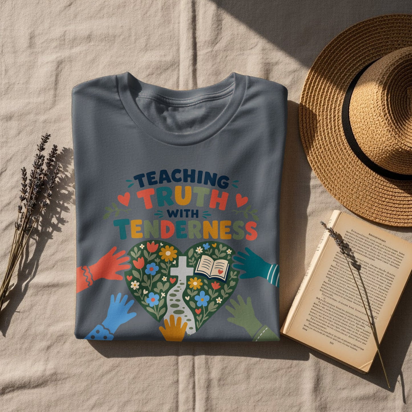 T-shirt with colorful "Teaching Truth With Tenderness" text and heart graphic.