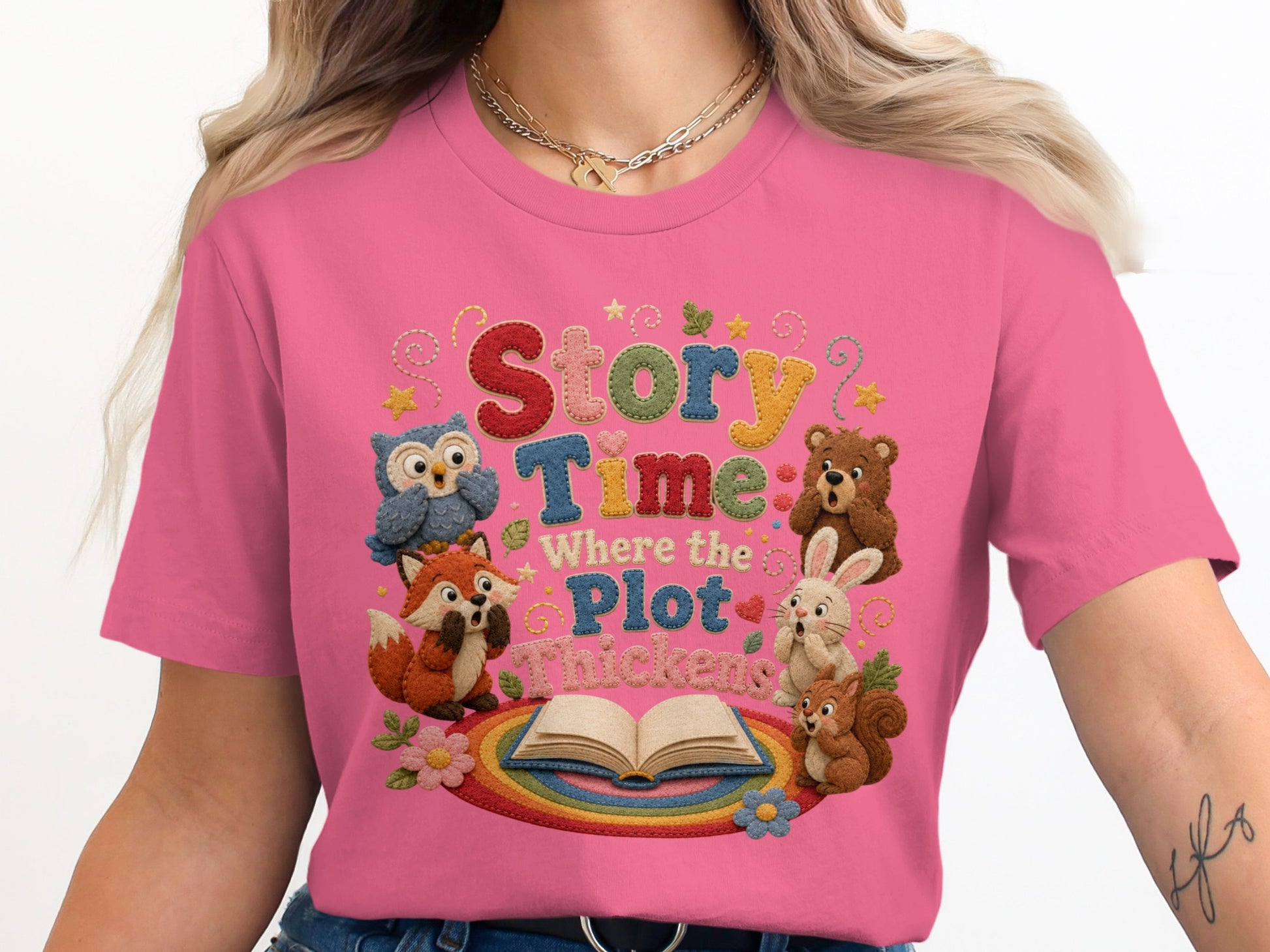 Pink t-shirt with 'Story Time: Where the Plot Thickens' text and embroidered animals.