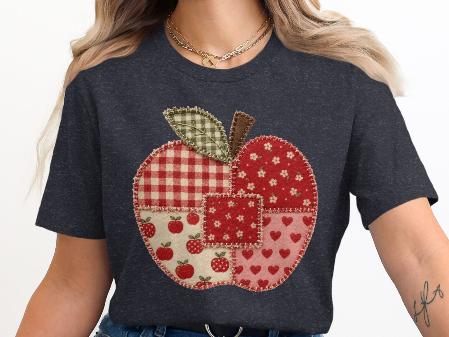 Dark gray t-shirt with a red apple graphic made of fabric patches.