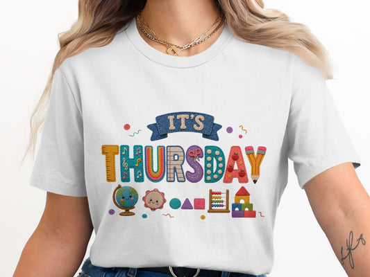 "IT'S THURSDAY" text with school-themed graphics on a white t-shirt.