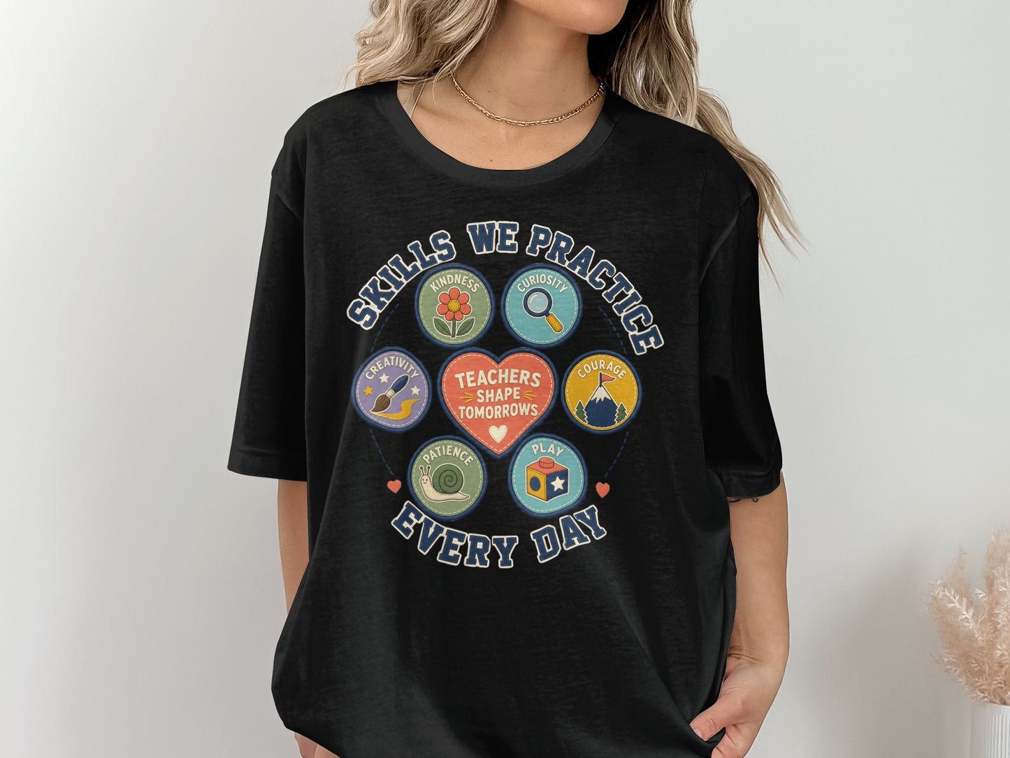 Black t-shirt with graphic design about teachers and skills practiced daily.