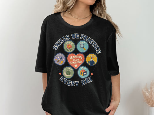 Black t-shirt with graphic design about teachers and skills practiced daily.