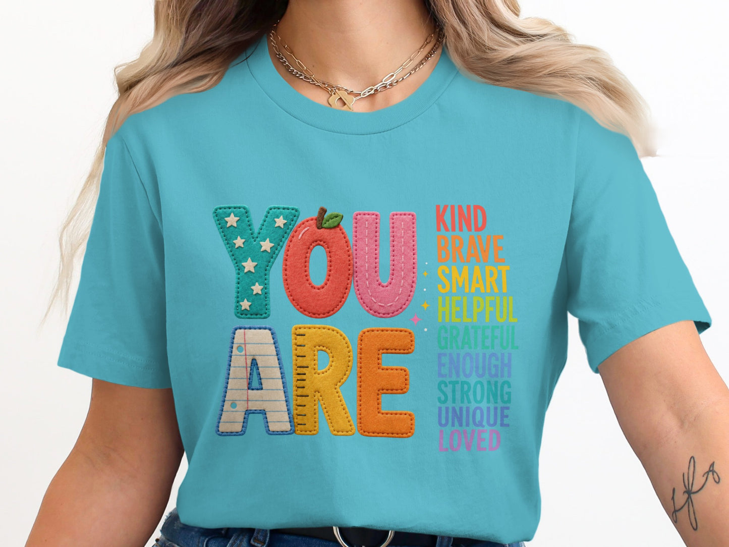 Turquoise shirt with "YOU ARE" and positive attributes for teachers.