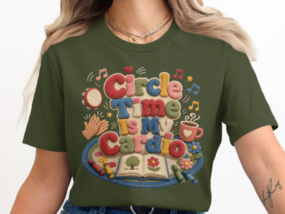 Green t-shirt with textured text "Circle Time Is My Cardio" and school-themed graphics.