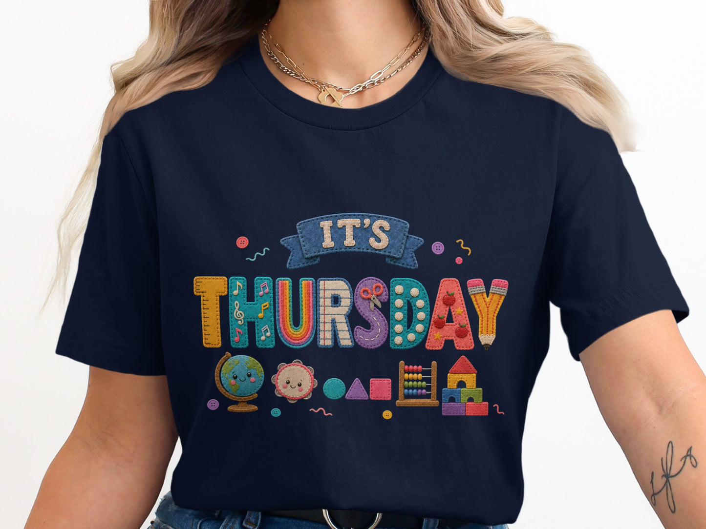 Navy t-shirt with "IT'S THURSDAY" text and school-themed graphics.