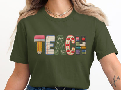 Green t-shirt with embroidered word TEACH made of school supplies.